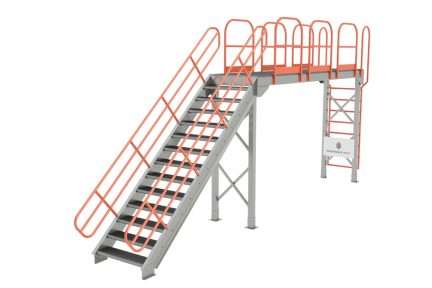 Structural steel catwalk mezzanine with a staircase and orange safety railing, designed as a walkway for accessing stored materials.