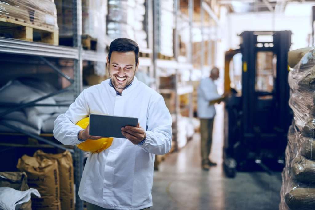 Man taking inventory at Pallet Racking aisle - speedrack west